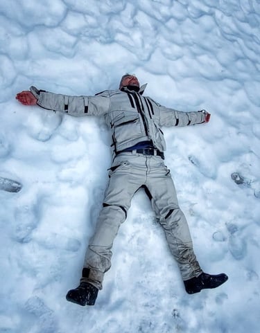 a man laying down in the snow